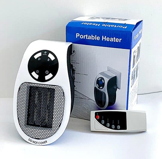 WarmAIR heater marked do not cover, beside a box labelled Portable Heater listing 500 W power and a small white remote control