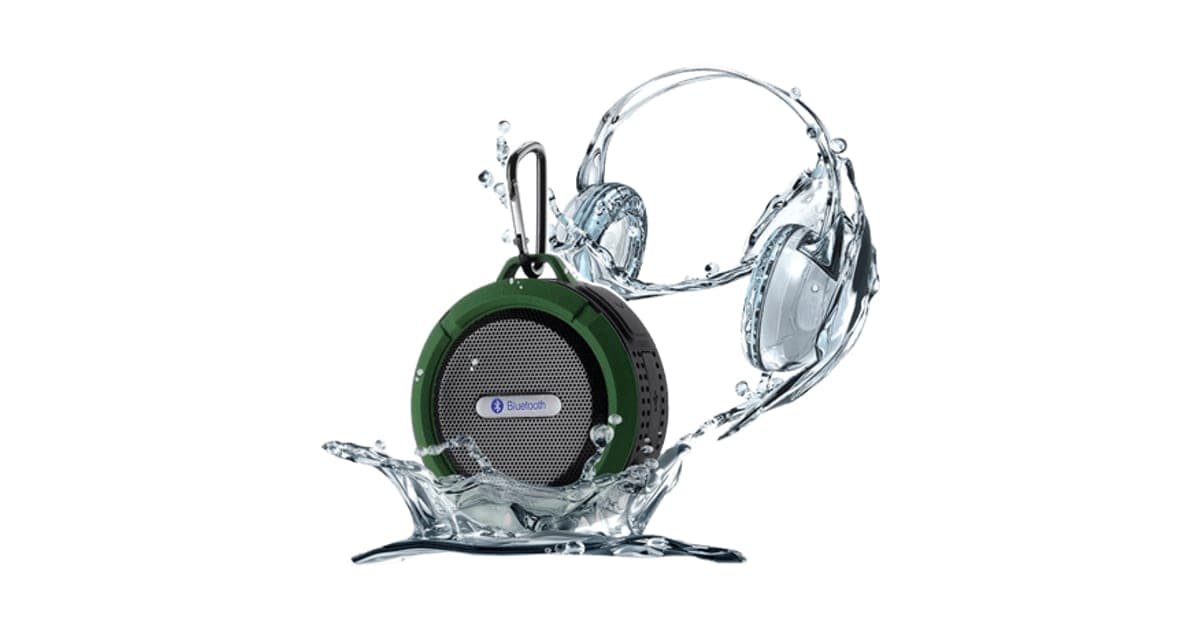 Round green and grey WaterBOOM 360 Bluetooth speaker with a black carabiner, surrounded by a water splash