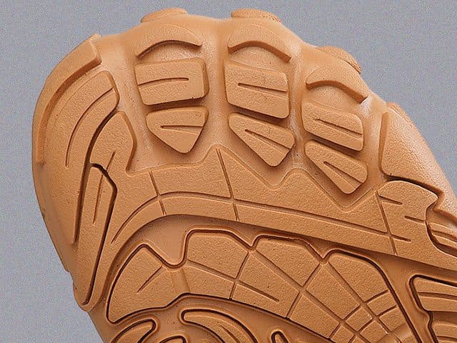 Close-up of the tan rubber sole of WinterGlide Pro with toe-shaped lugs
