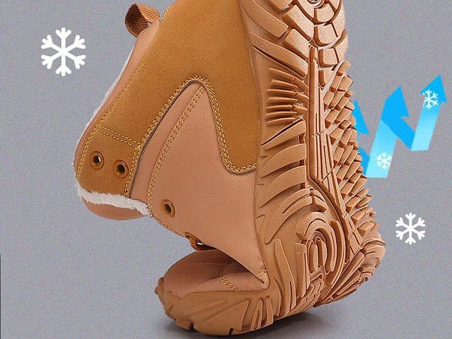 WinterGlide Pro boot bent heel to toe to show its flexible sole, with snowflakes and a blue arrow