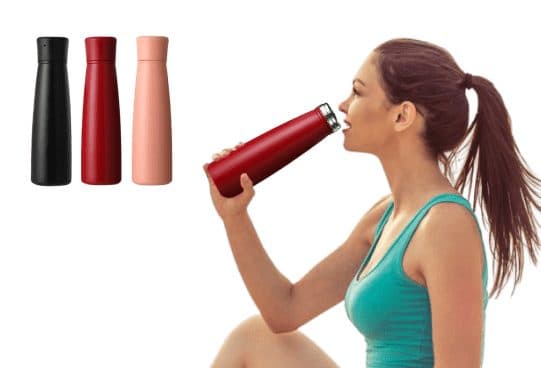 Three slim AcquaSan Pro bottles in black, dark red and pale pink, and a woman drinking from the red one