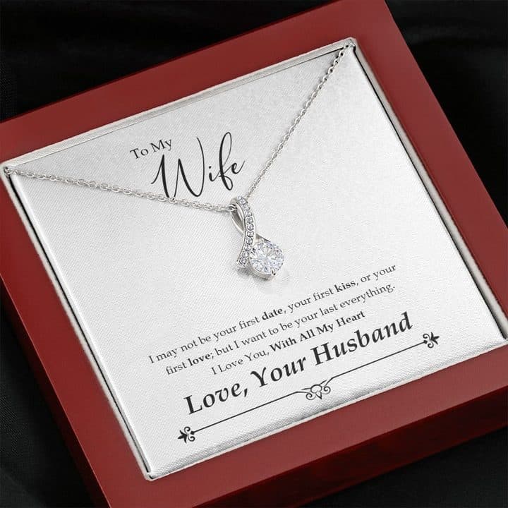 Close view of the silver-tone ribbon pendant and clear stone on the To My Wife card in a red-brown box