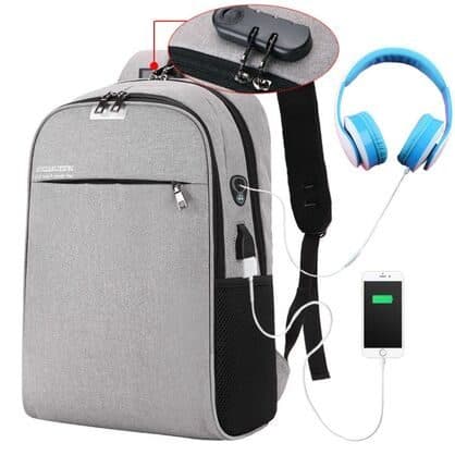 Grey BackXPack with a close-up of a black combination lock holding the top zip pulls, and headphones and a phone connected to the side ports