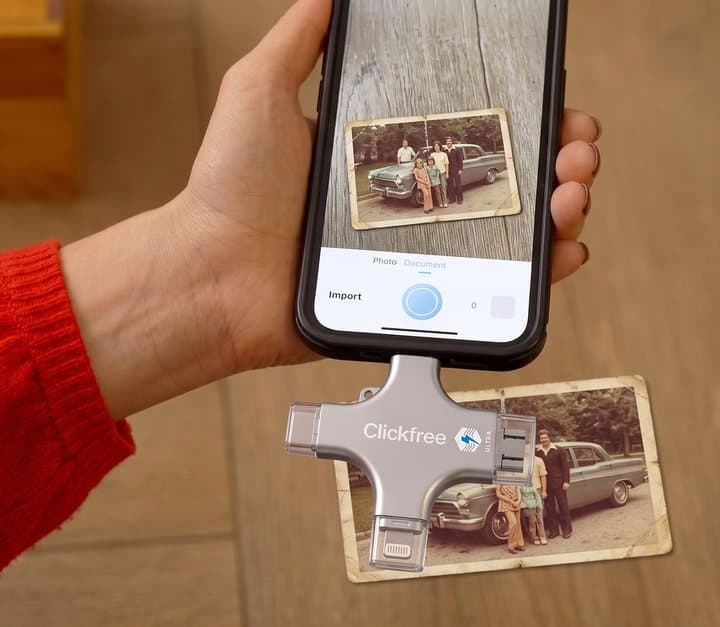 Phone with a Clickfree drive attached photographing an old printed photo on a table
