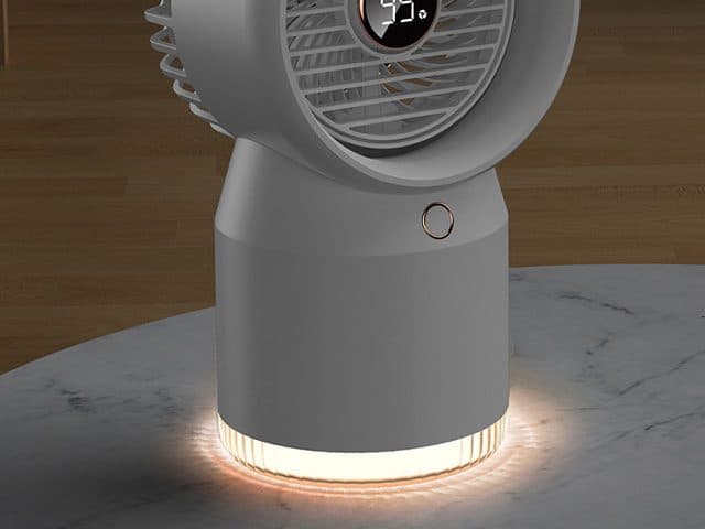 Grey CoolSpot on a marble table with its translucent base glowing warm amber as a night light