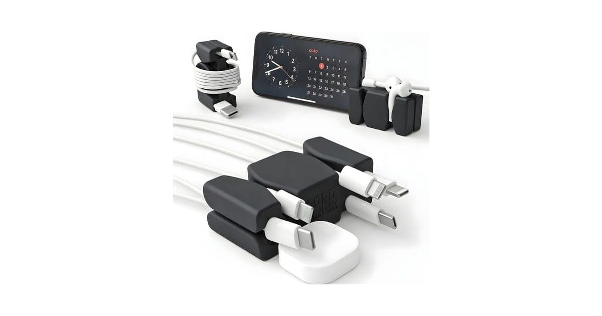 Black CordBrick weighted cord holders gripping white charging cables beside a phone on a stand