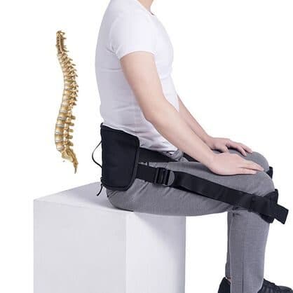 Seated man wearing a black CorrectBack back pad with straps to the knees, shown next to a golden spine illustration