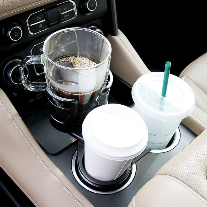 Dual CupStation holding a glass coffee mug with a handle above a paper coffee cup in a car