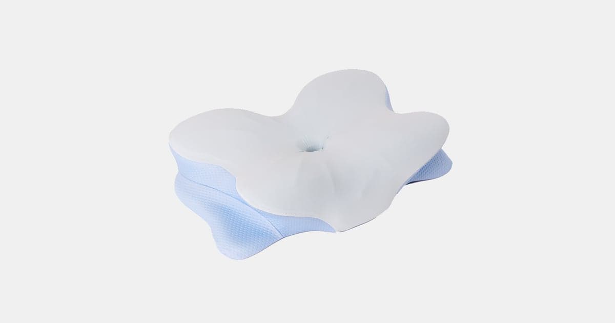 Derila Ergo memory foam pillow in its light blue and grey cover, showing the butterfly outline and the dimple in the centre