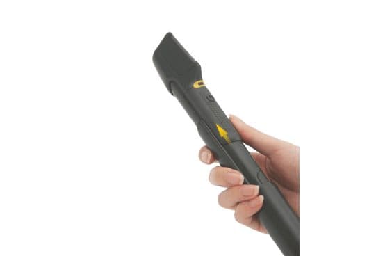 Hand gripping a grey EasyTrim Pro with a flat angled cutting head, a yellow power ring and an arrow on the grip