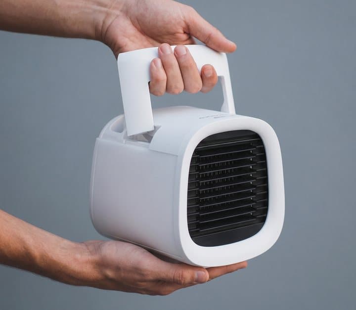 Hands carrying a white evaCHILL cooler by its fold-up handle