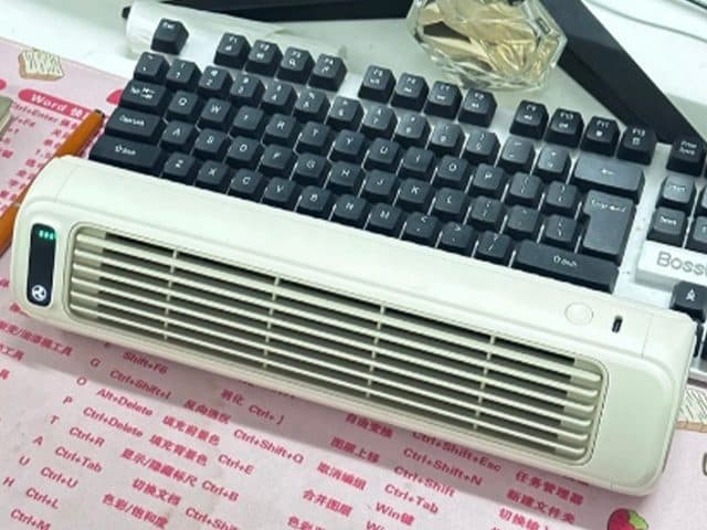 Cream FreshAir Pro lying flat on a desk in front of a keyboard, with louvres, a power indicator and a button