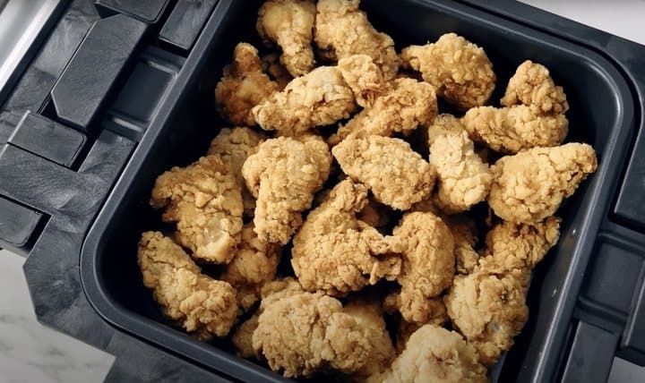 Breaded chicken pieces in the Gourmax Pro air frying basket