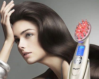 Similar gold red-light comb printed with the CkeyiN name and a blue screen, next to a woman with long dark hair, used for the EMS massage add-on