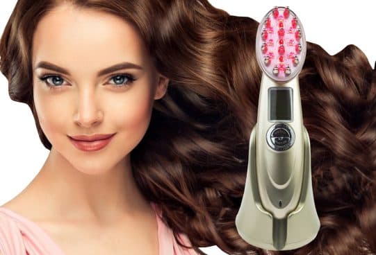 HairRevit Pro champagne gold comb with red glowing lights and metal-tipped bristles, a digital display and control buttons, beside a woman with wavy brown hair