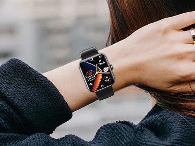 HealthWatch Pro with a black strap worn on a wrist, showing an analogue-style face with heart rate and step counts