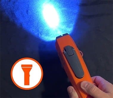 Kelvin 8 flashlight shining a bright blue-white beam in the dark