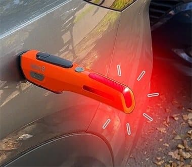 Kelvin 8 stuck to the side of a car by its magnets with its red strobe lit