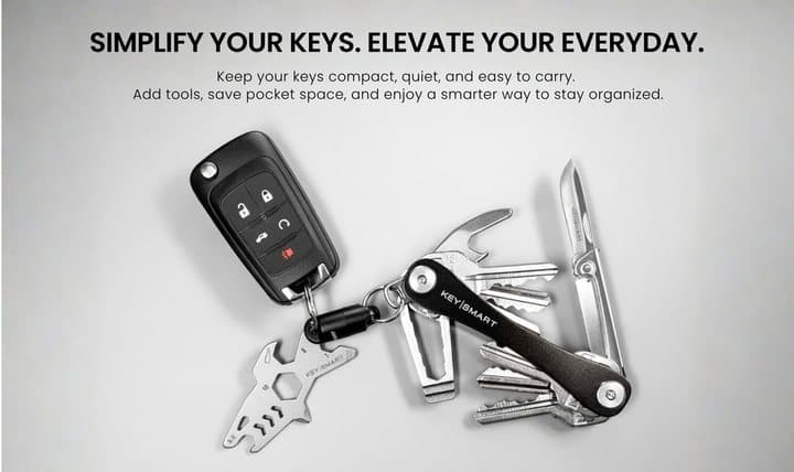 KeySmart with keys, a car fob and add-on tools laid out on a light surface