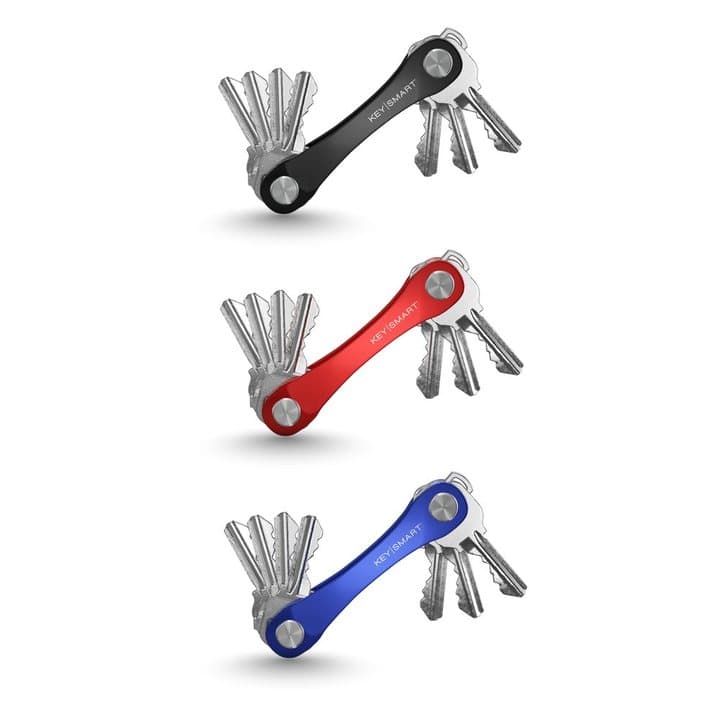 Black, red and blue KeySmart Original organizers each holding a set of keys