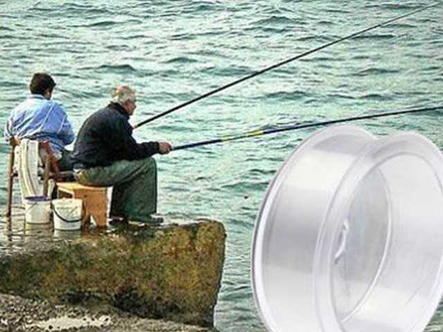 Two men fishing with long rods from a rocky shore, with a spool of clear fishing line in the foreground