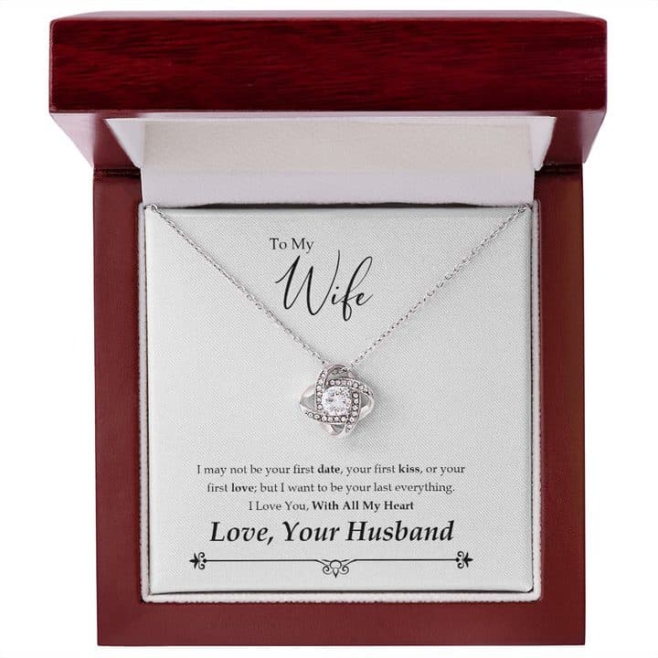 Silver-tone Love Knot Necklace on its To My Wife card inside an open glossy red-brown mahogany-style box