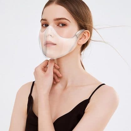 Woman wearing a clear LucidShield over her nose and mouth with gaps visible at the sides and under the chin