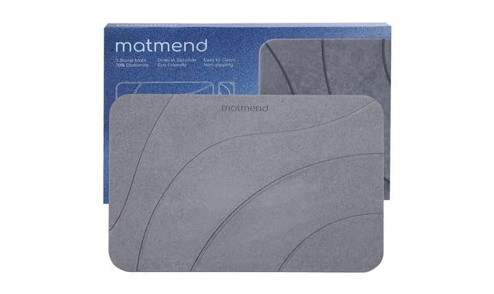 MatMend stone bath mat in front of its blue retail box