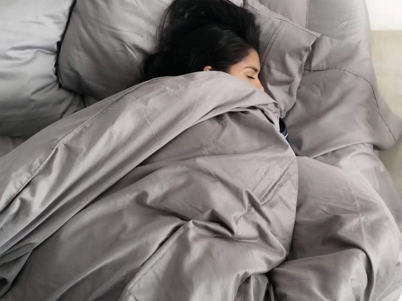 Person asleep under grey Miracle Made sheets with matching pillowcases