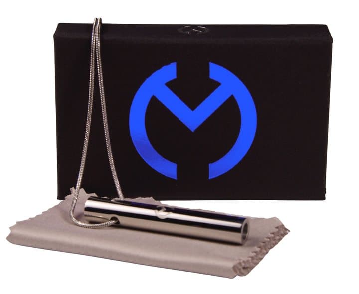 Silver Moksha Beam pendant and chain on a grey cloth in front of its black presentation box