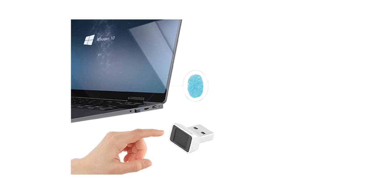 Small silver and black NanoSecure USB fingerprint reader being touched by a finger beside a laptop showing Windows 10