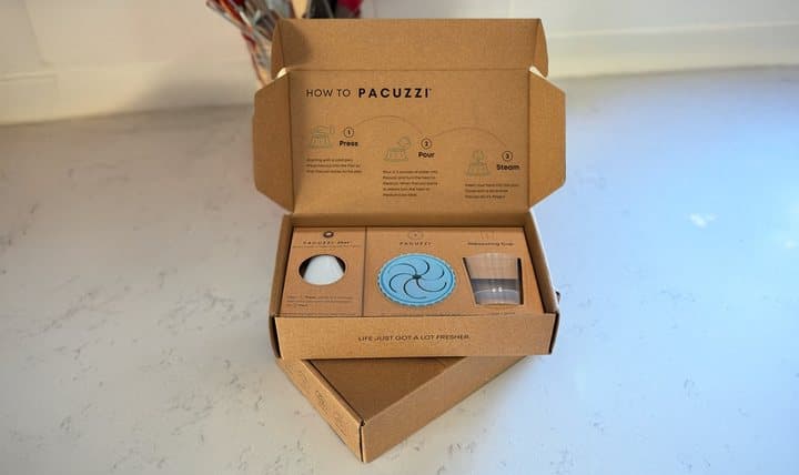 Open Pacuzzi shipping box showing the steamer cup and instructions