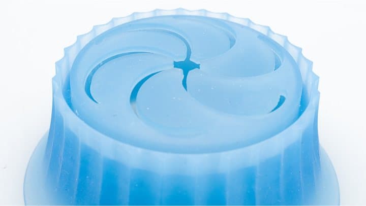 Close-up of the blue Pacuzzi silicone steamer cup with its swirl-patterned lid