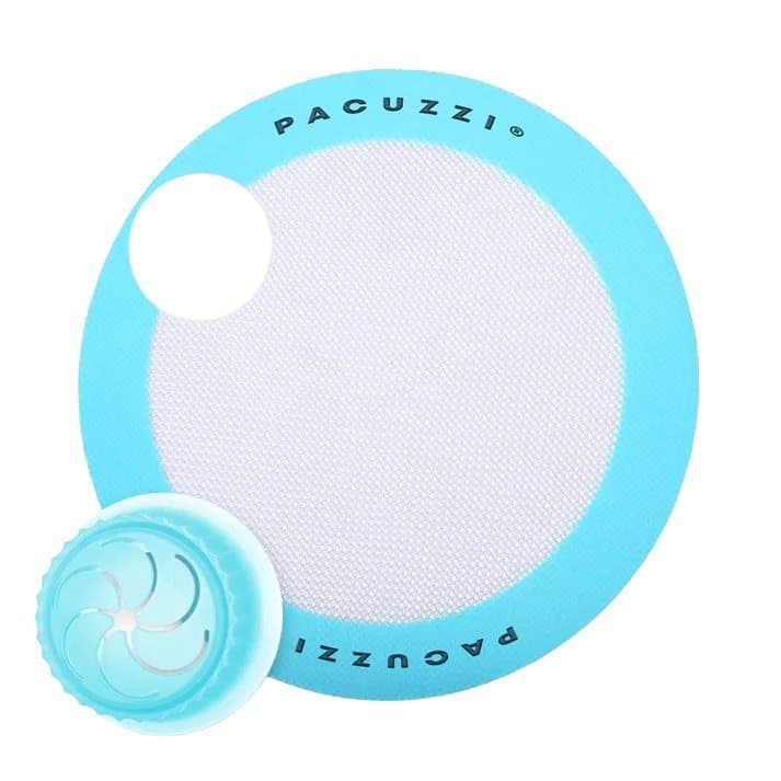 Pacuzzi steamer cup next to its round blue-rimmed silicone baking mat