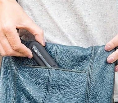 Black Peeps cleaner being slipped into the pocket of a leather bag