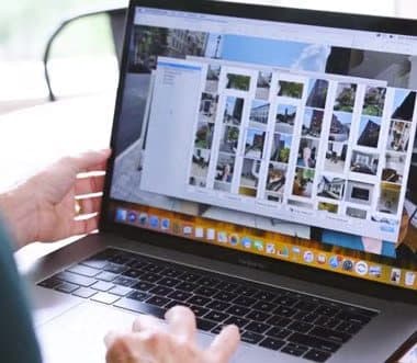 Laptop screen showing a grid of photos found by ThePhotoStick