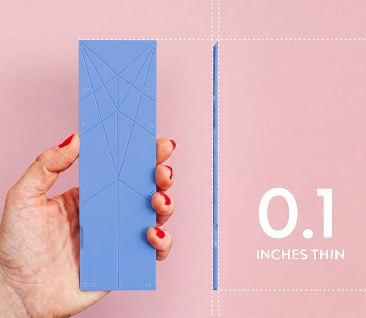 Hand holding a flat blue Polygons card next to a label reading 0.1 inches thin