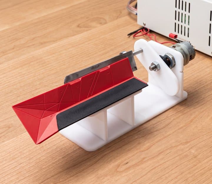 Polygons card mounted in a machine that repeatedly folds it for durability testing