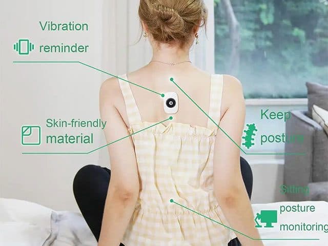Woman seen from behind wearing the PostureRemind Pro on her upper back, labelled vibration reminder, skin-friendly material, keep posture and sitting posture monitoring