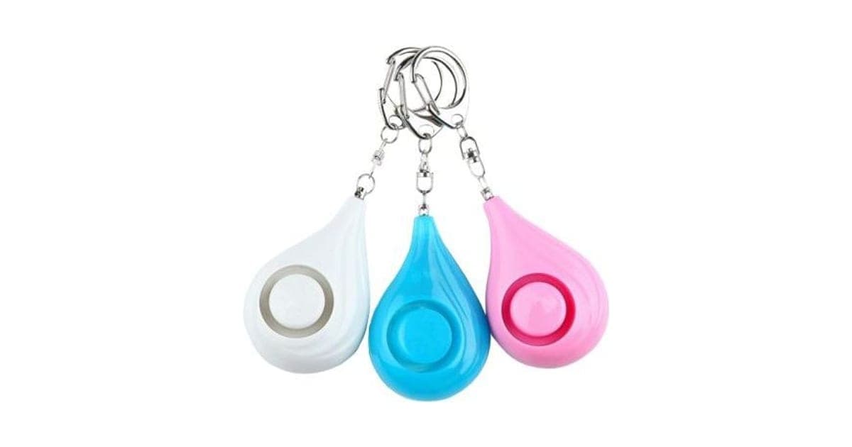 Three teardrop Protector Pitch keychain alarms in white, blue and pink with round centre buttons and metal key rings