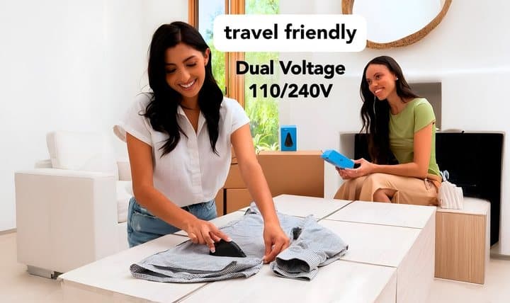 Woman ironing a shirt on a coffee table with riddiaPress, labelled travel friendly dual voltage 110/240V