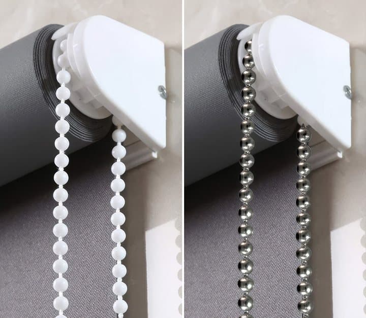 Close-up of a roller blind's looped beaded chain in white and metal versions