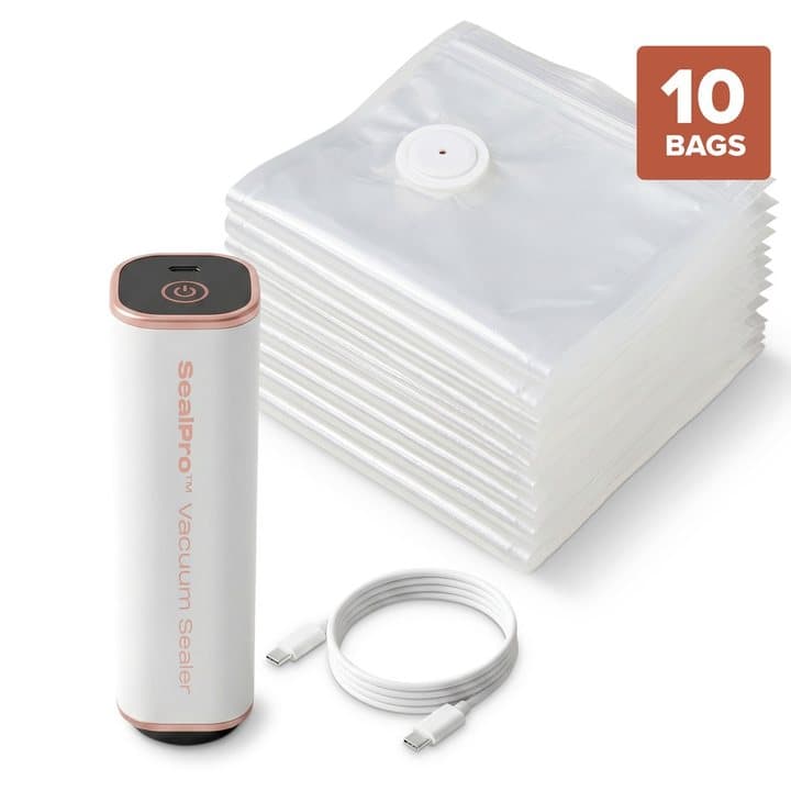 SealPro vacuum sealer with a stack of reusable vacuum bags and a USB charging cable