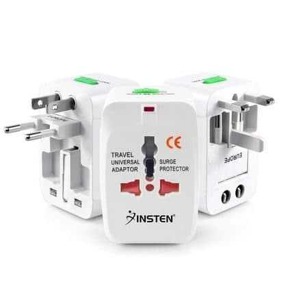 Three white universal travel adapters labelled Insten, with fold-out pins for different countries