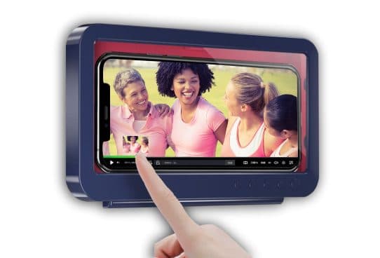 Navy and red ShowerTime Max case showing a phone playing a video of four smiling women, with a finger touching the clear front