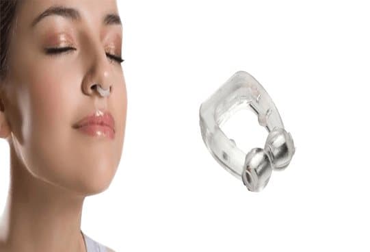 Woman asleep wearing the clear SilentSnore clip in her nostrils, beside a close-up of the clip with two silver tips