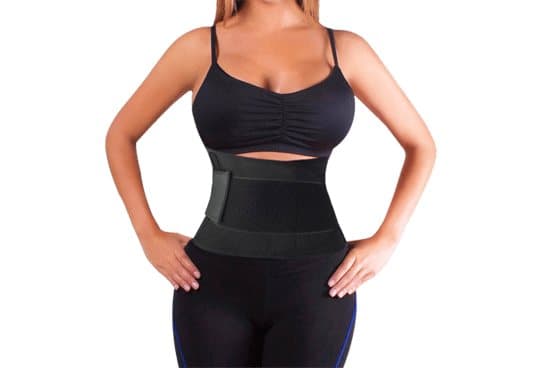 Woman in a black crop top and leggings wearing the black SlimShaper neoprene belt around her waist