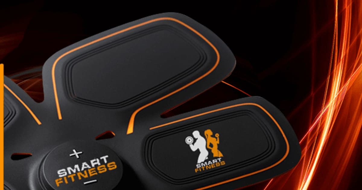Smart Fitness six-panel EMS abs pad with orange edging and a round control unit marked Smart Fitness, on a dark background