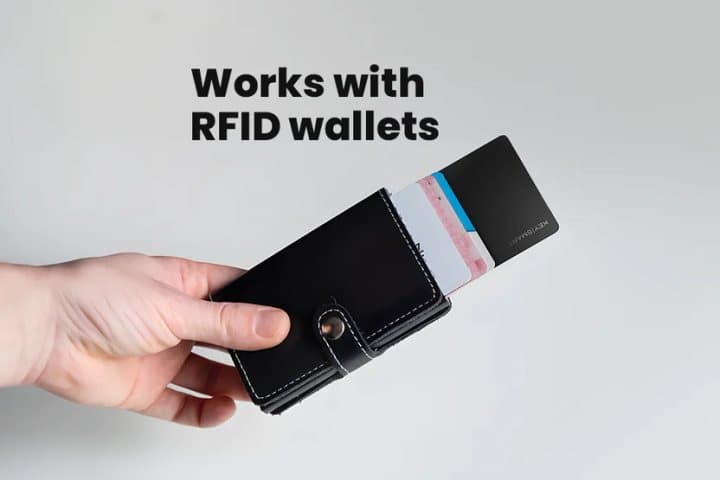Hand holding a black card-style wallet with a SmartCard sliding out among the cards