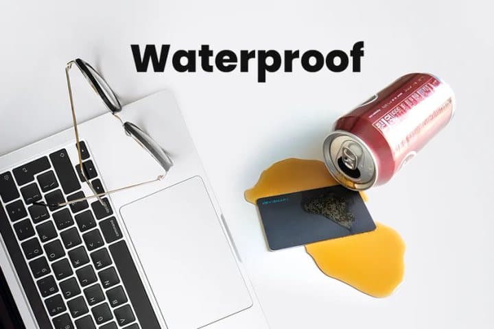 SmartCard lying in spilled drink next to a laptop and a tipped-over can